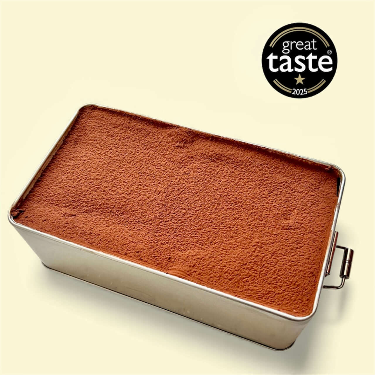 Classic Tiramisu 700g dessert in a metal container topped with cocoa powder and marked as a Great Taste Award winner 2025.