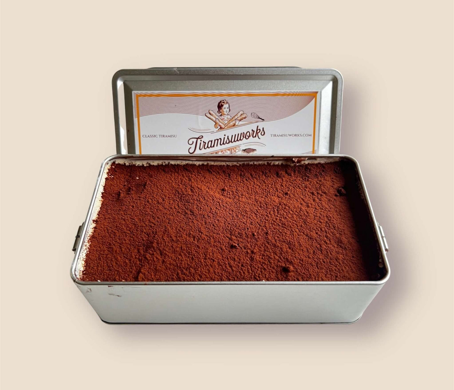 Classic tiramisu in a metal tin, freshly made and ready to serve, ideal for 4 people.
