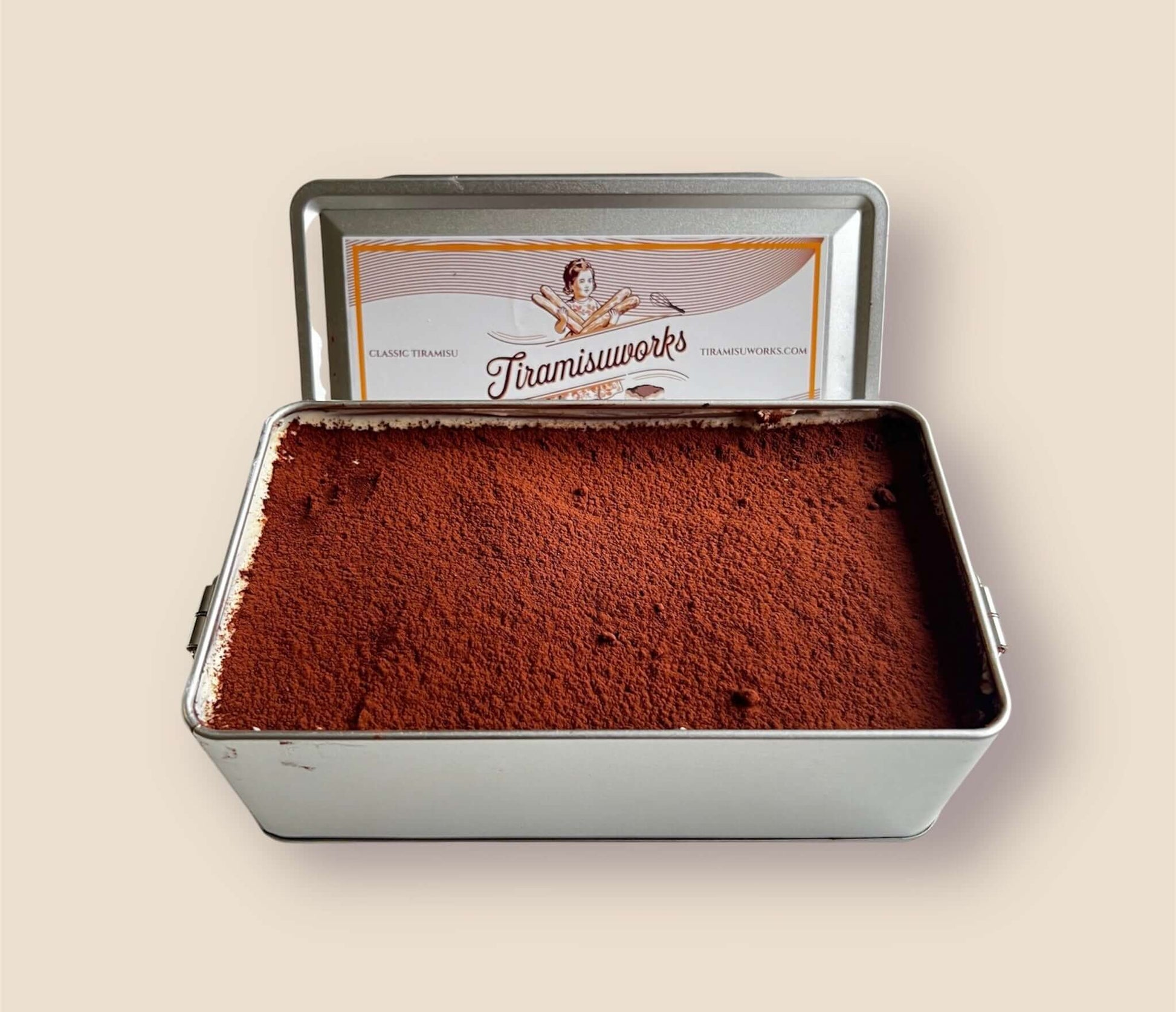 Classic tiramisu in a metal tin, freshly made and ready to serve, ideal for 4 people.