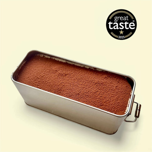 Classic Tiramisu 310g in sleek metal container, decorated with cocoa powder, awarded Great Taste 2025.