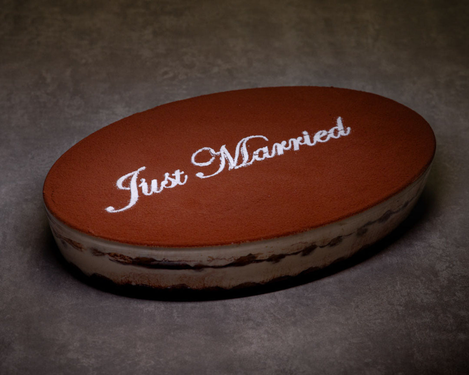 Luxury Italian tiramisu wedding cake personalised with “Just Married” for weddings and events in the UK.