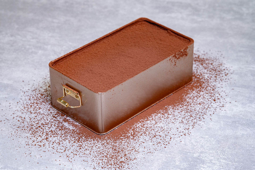 Luxury handmade tiramisu tray dusted with cocoa powder, made using an award-winning recipe and available for weddings, birthdays and events across the UK.
